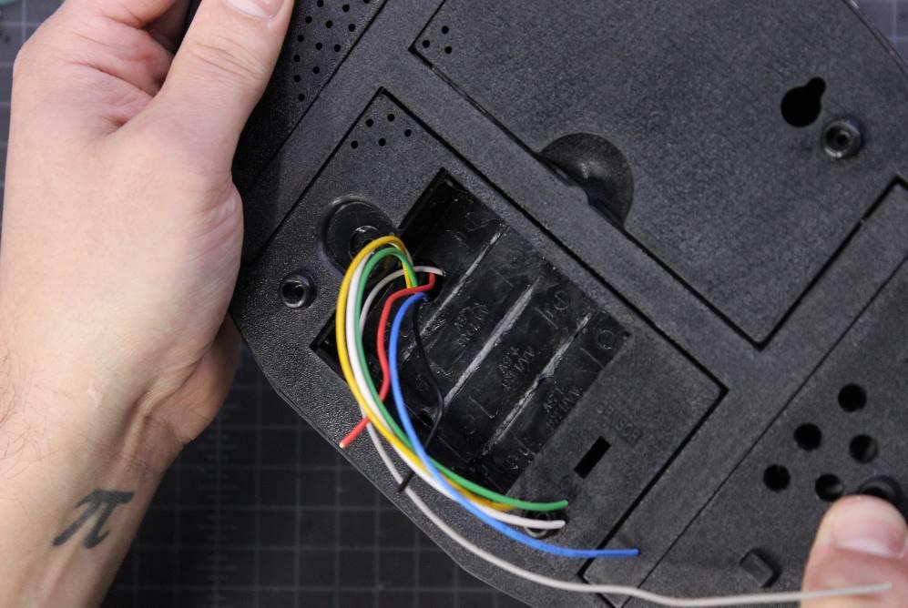 Push the wires through the hole and screw the case