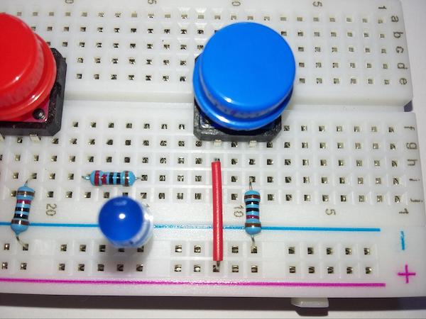 Connecting the pushbutton and LED on the breadboard.